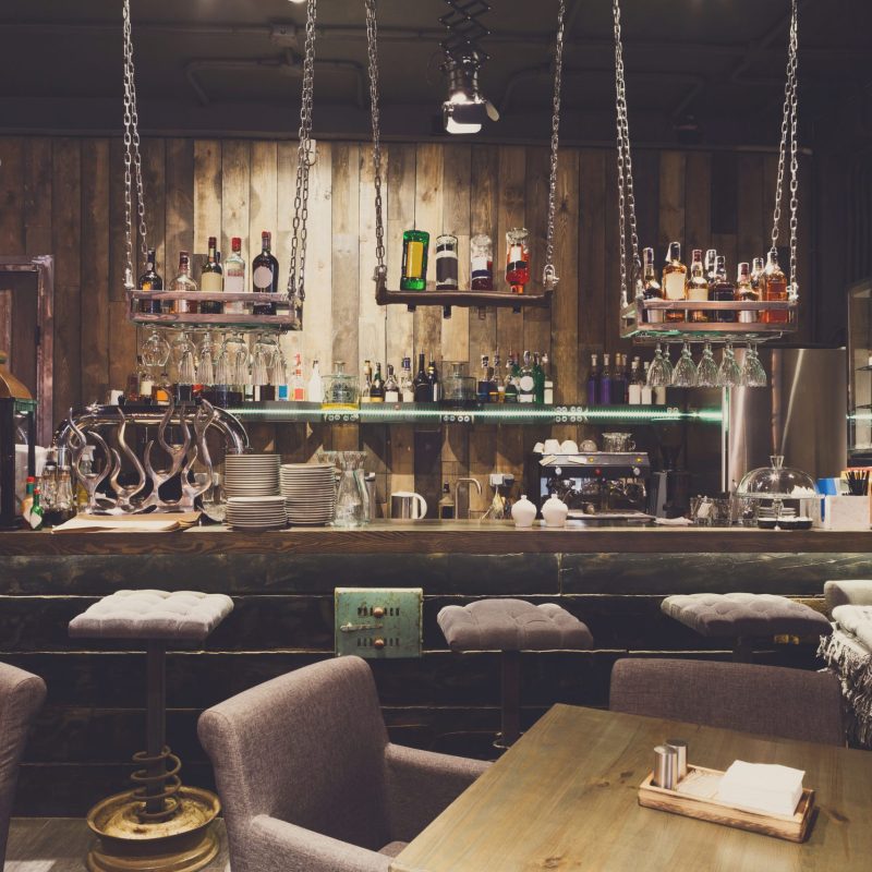 Interior of cozy restaurant. Contemporary design in loft style, modern dining place and bar counter, copy space